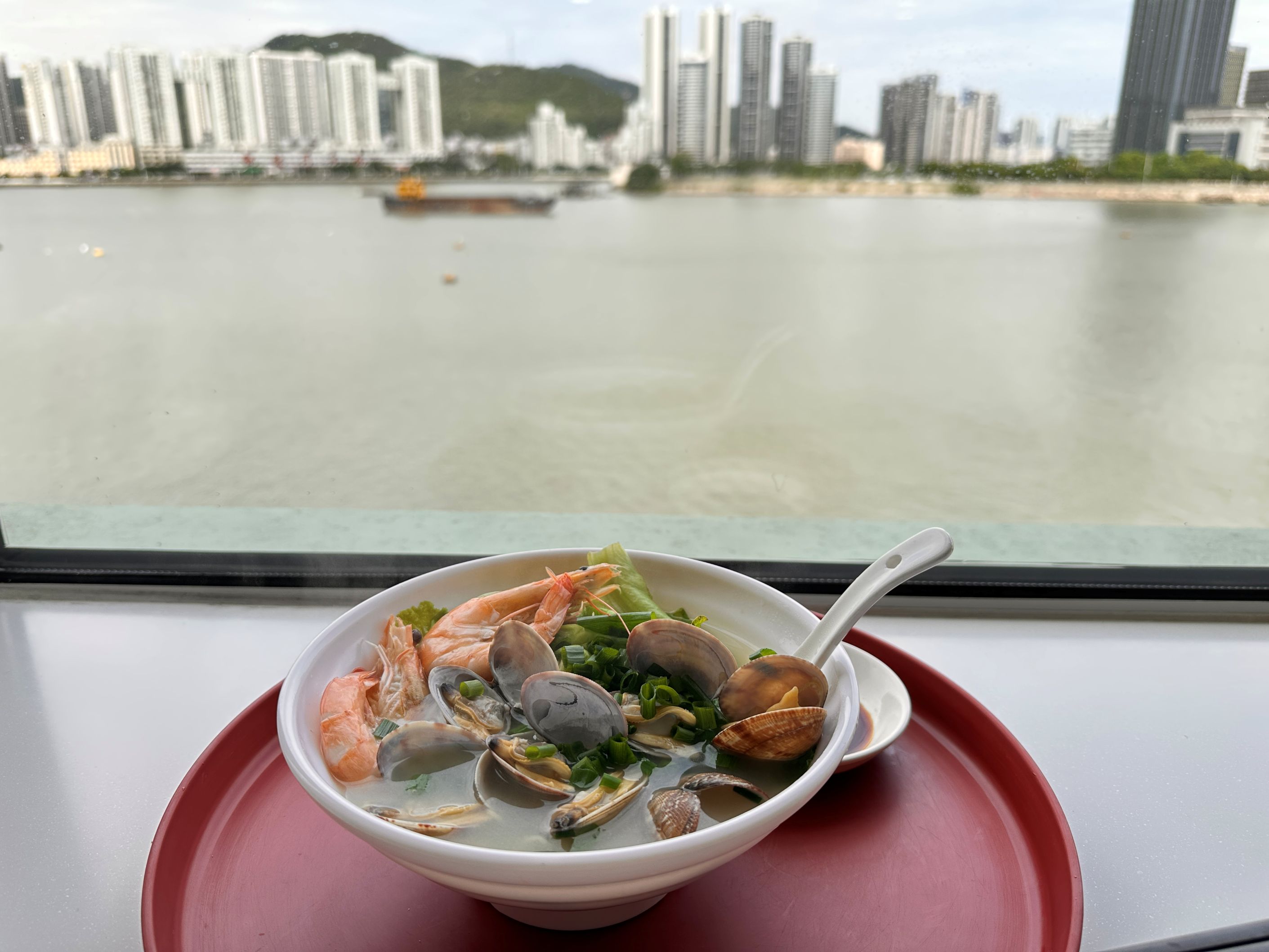 Savoring seafood noodles while herons and egrets put on a show right outside
